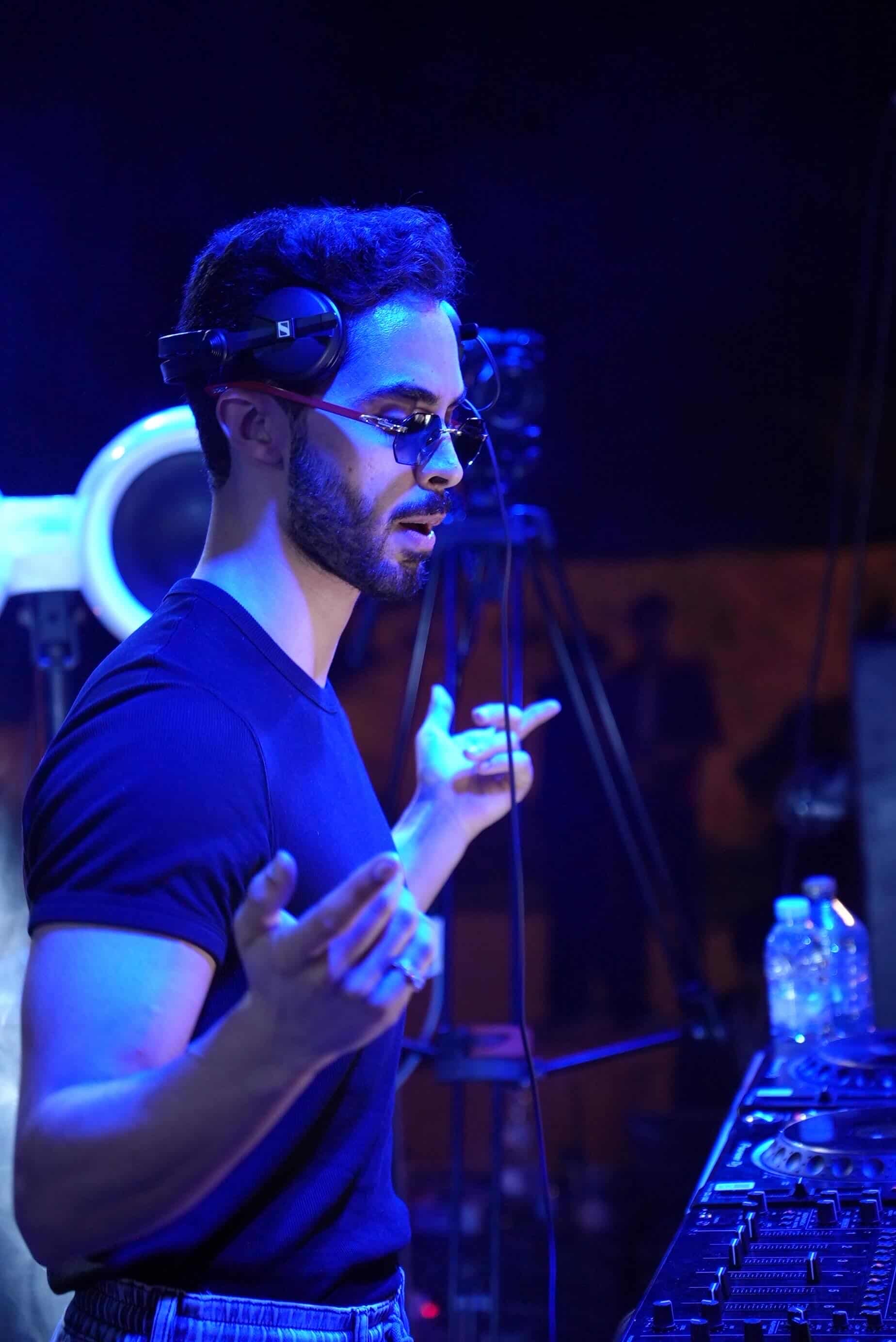 Omar Kyle performing under cold blue stage light